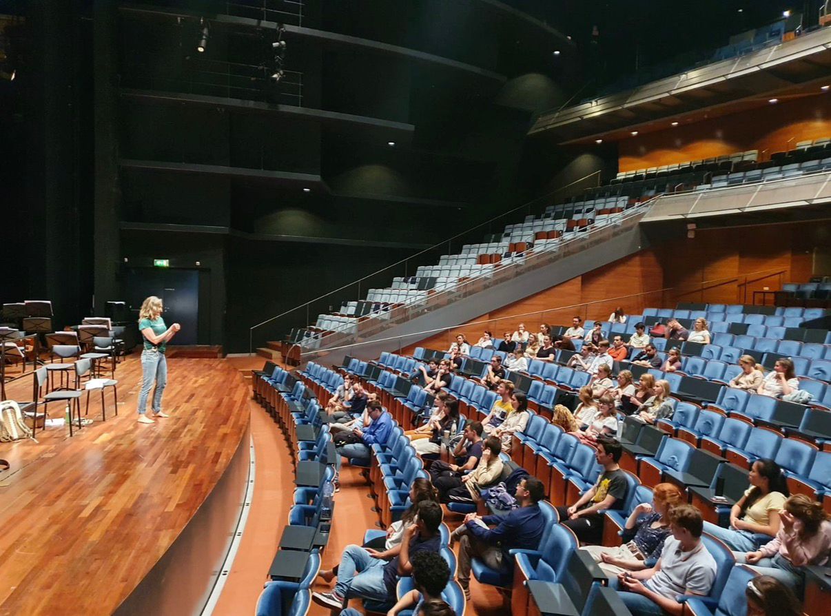 Ellen presenting in concert hall